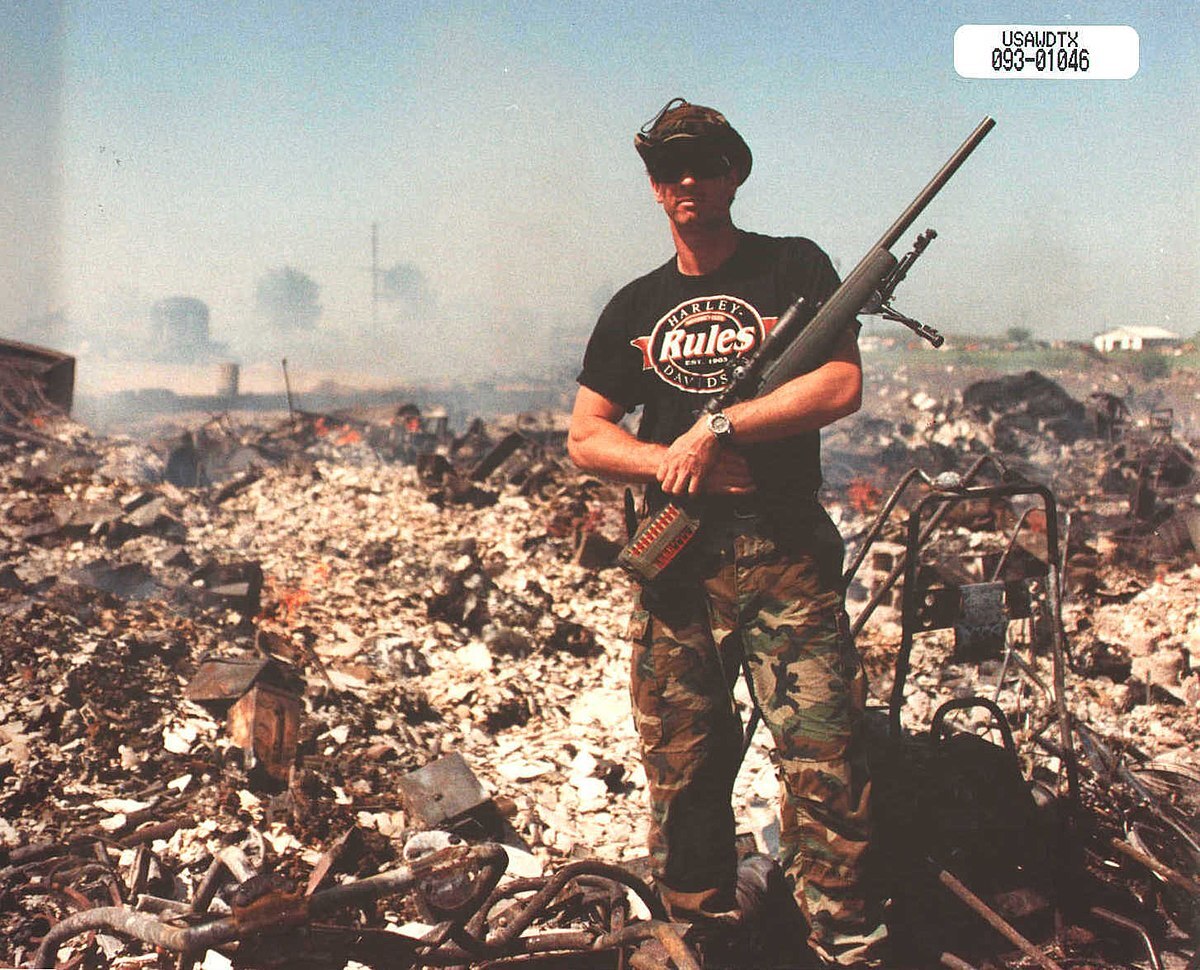 Click image for larger version

Name:	USAWDTX_093-01046_–_Unidentified_fed_posing_with_corpse_at_Waco_No._2.jpg
Views:	1489
Size:	310.1 KB
ID:	473440