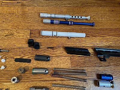 Bolts, sight rails, right feed body caps, and a detent cover. I don't remember the brand of the white delrin bolt, but it seems pretty nice.
